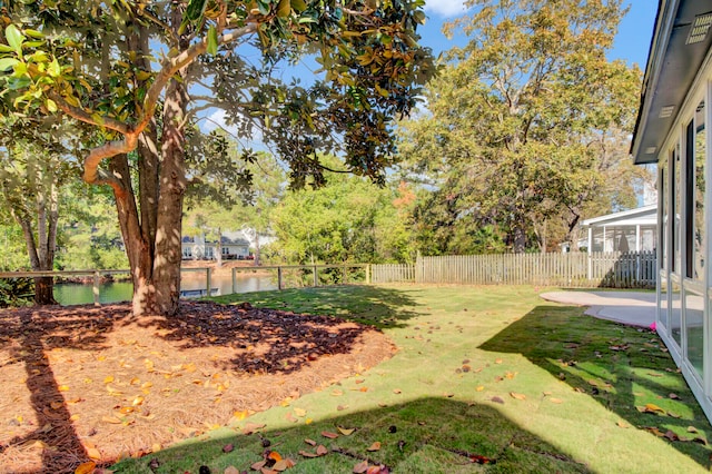 view of yard featuring a water view and a patio area