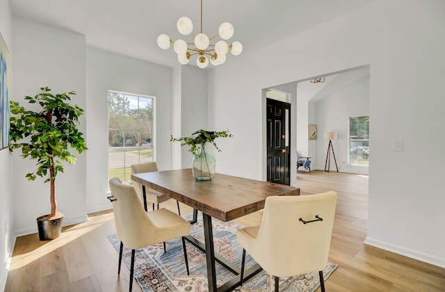 dining area with an inviting chandelier and light wood-type flooring