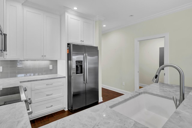 kitchen with white cabinetry, stainless steel fridge with ice dispenser, and light stone countertops