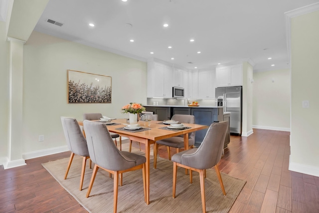 dining area with dark hardwood / wood-style flooring