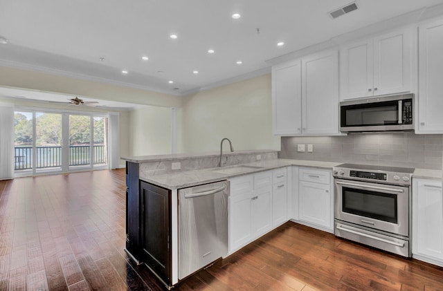 kitchen with kitchen peninsula, white cabinetry, and stainless steel appliances