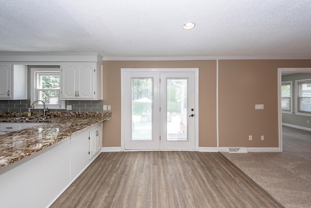 102 Six Point Ct, Goose Creek, SC 29445 - kitchen featuring white cabinetry, dark stone countertops, baseboards, a textured ceiling, and a sink