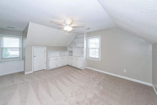 102 Six Point Ct, Goose Creek, SC 29445 - additional living space featuring a textured ceiling, light carpet, vaulted ceiling, ceiling fan, and baseboards