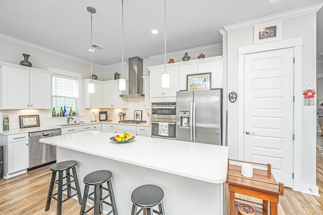 1515 Pogonia St Unit 2, Mount Pleasant, SC 29466 - kitchen with stainless steel appliances, wall chimney exhaust hood, a kitchen bar, a sink, and ornamental molding