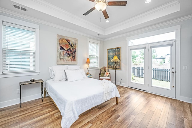 1515 Pogonia St Unit 2, Mount Pleasant, SC 29466 - bedroom with access to exterior, a tray ceiling, light wood-type flooring, baseboards, and ornamental molding