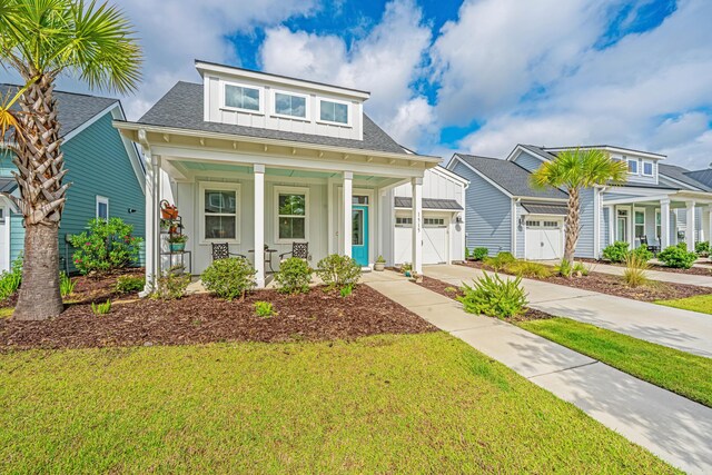 1515 Pogonia St Unit 2, Mount Pleasant, SC 29466 - view of front of property featuring covered porch, concrete driveway, a front yard, and a garage