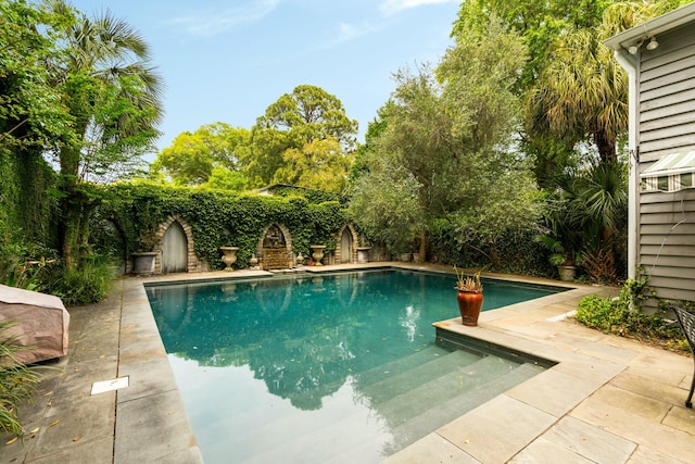 view of swimming pool featuring a fenced in pool, a patio, and a fenced backyard