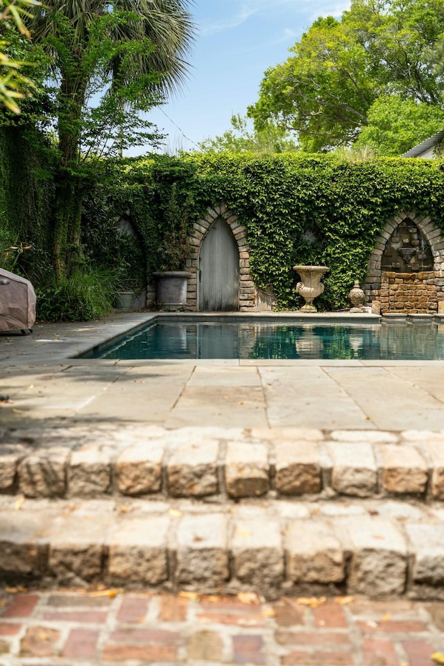 view of pool with a patio and a fenced backyard