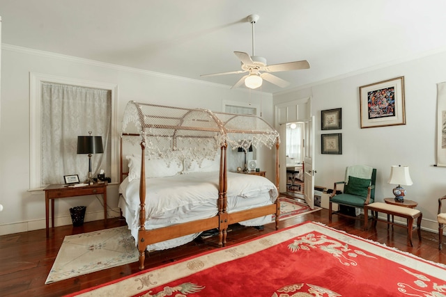 bedroom with crown molding, baseboards, and hardwood / wood-style floors
