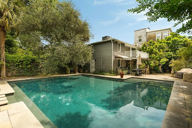 outdoor pool with a patio area