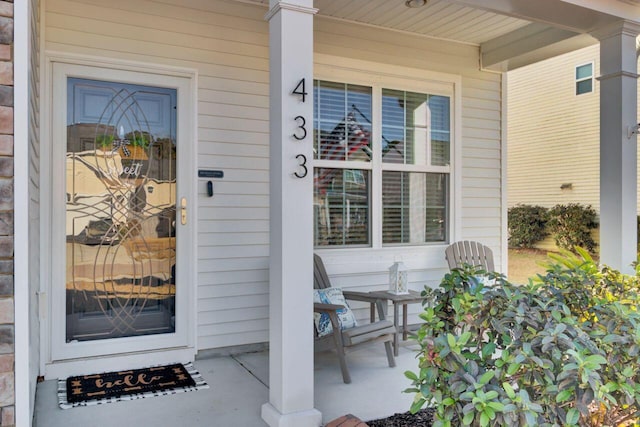 entrance to property featuring a porch