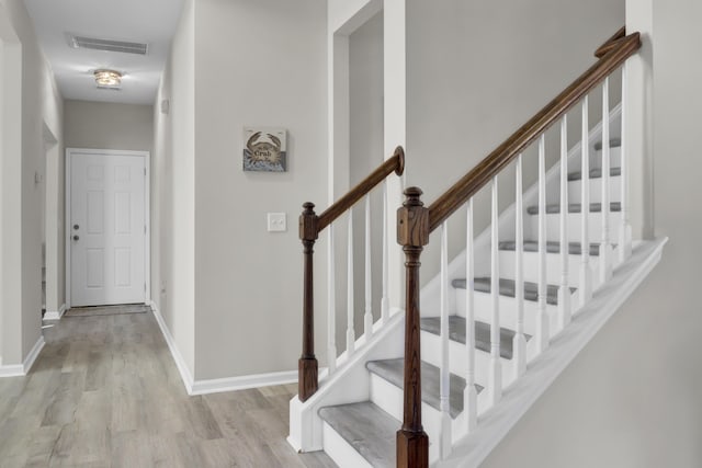 stairway featuring hardwood / wood-style floors