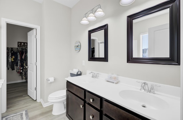 bathroom featuring vanity, hardwood / wood-style flooring, and toilet