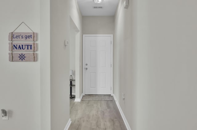 hall with light hardwood / wood-style floors