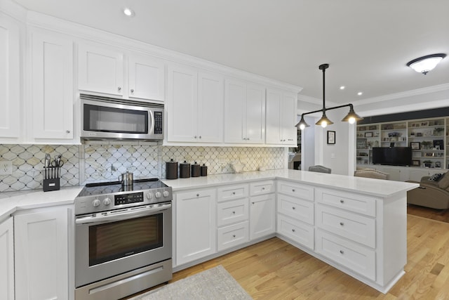 189 Fox Chase Dr, Goose Creek, SC 29445 - kitchen with appliances with stainless steel finishes, open floor plan, crown molding, white cabinets, and a peninsula