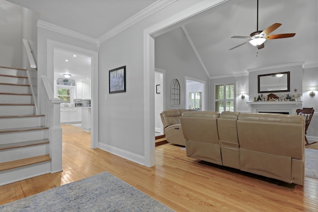 189 Fox Chase Dr, Goose Creek, SC 29445 - living room with light wood-type flooring, ceiling fan, stairway, a fireplace, and plenty of natural light