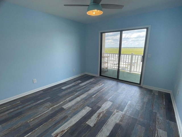 spare room featuring dark hardwood / wood-style floors and ceiling fan