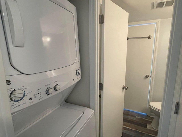 laundry area featuring stacked washing maching and dryer