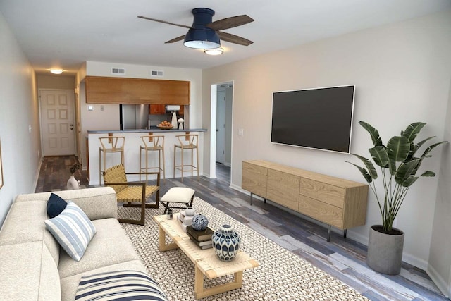 living room featuring ceiling fan and hardwood / wood-style floors