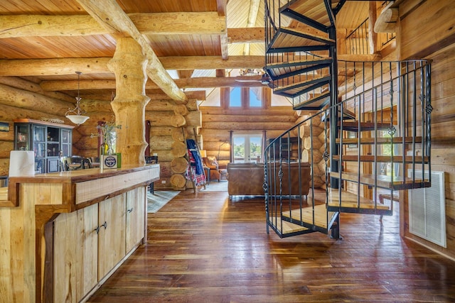 interior space with rustic walls, hardwood / wood-style floors, beamed ceiling, wooden ceiling, and butcher block countertops