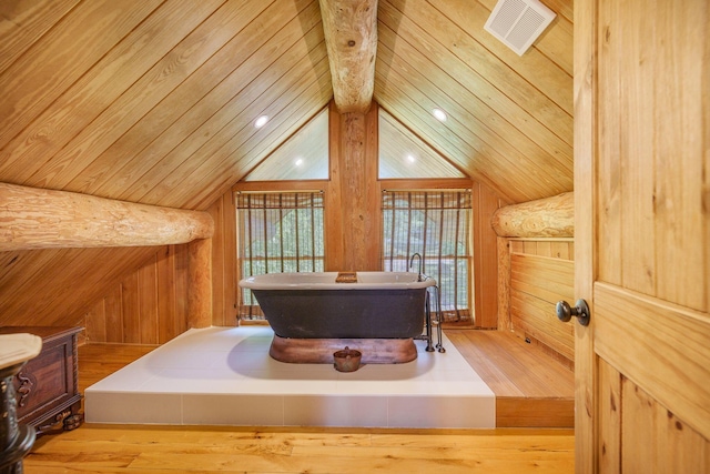bathroom featuring a freestanding bath, wood finished floors, wooden ceiling, and wood walls