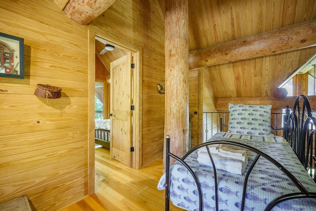 bedroom featuring wood walls and wood finished floors