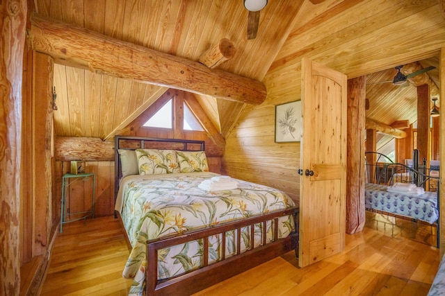 bedroom with wooden ceiling, wood-type flooring, multiple windows, and wooden walls