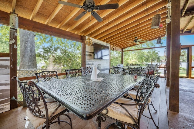 view of patio featuring outdoor dining area, ceiling fan, and a deck