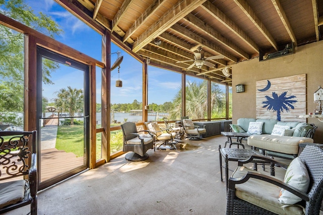 sunroom / solarium with a water view, ceiling fan, carpet flooring, outdoor lounge area, and beamed ceiling