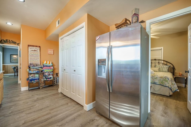 kitchen with stainless steel fridge with ice dispenser, light wood-type flooring, baseboards, and recessed lighting