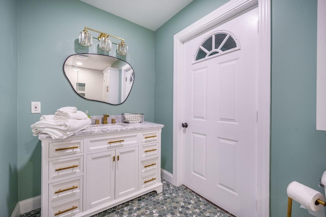 bathroom with vanity and baseboards