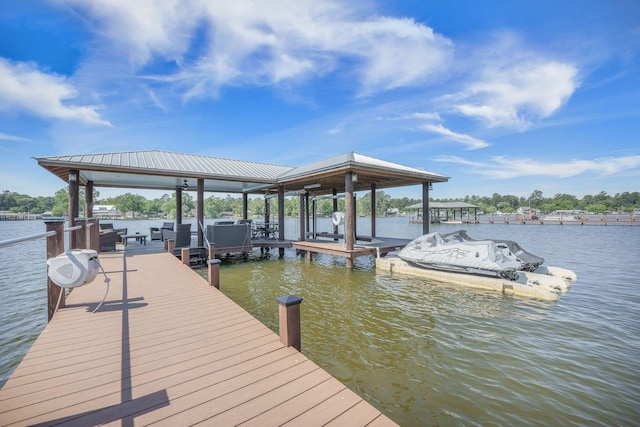 dock featuring boat lift and a water view