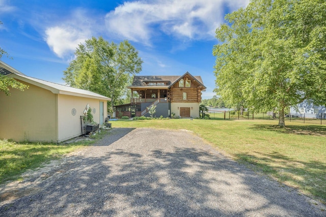 view of front of house featuring log siding and driveway