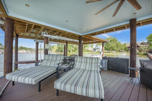 wooden deck featuring a water view and a ceiling fan
