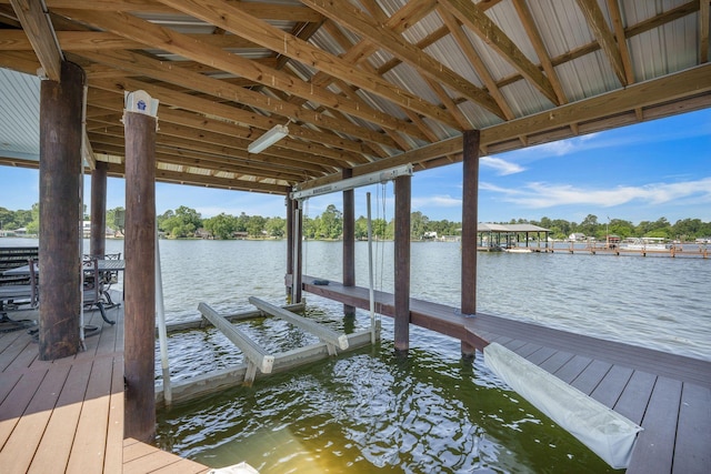 dock area with boat lift and a water view