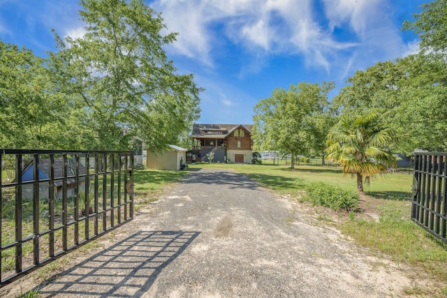 view of front of house with driveway and a gate