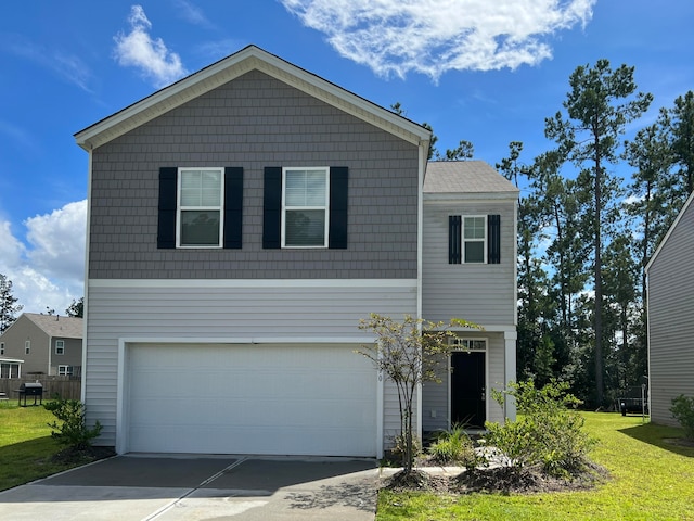 view of front property featuring a front yard and a garage