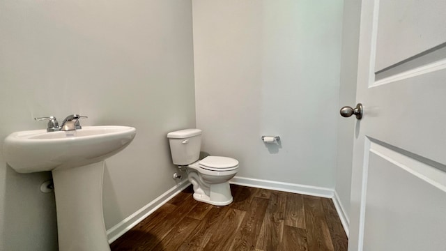 bathroom featuring toilet and hardwood / wood-style flooring