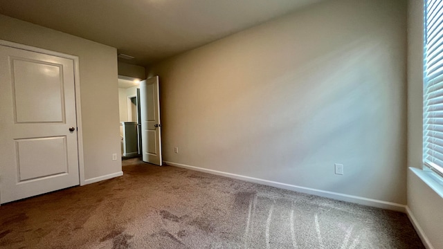 unfurnished bedroom featuring dark colored carpet