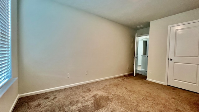 unfurnished bedroom with light carpet