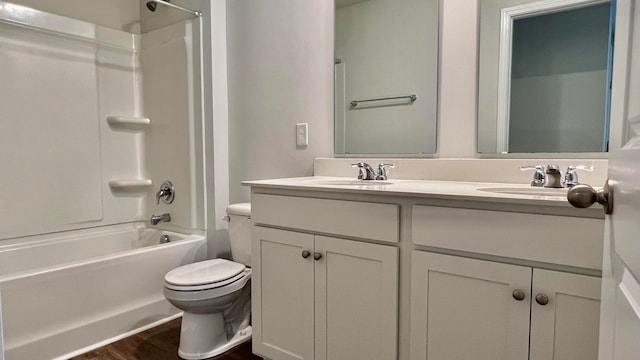 full bathroom featuring shower / tub combination, toilet, dual bowl vanity, and hardwood / wood-style floors