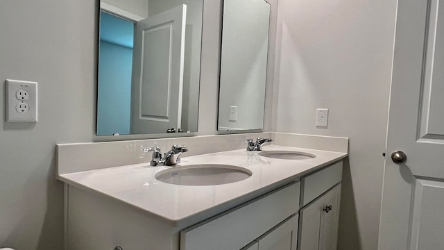 bathroom featuring dual sinks and large vanity