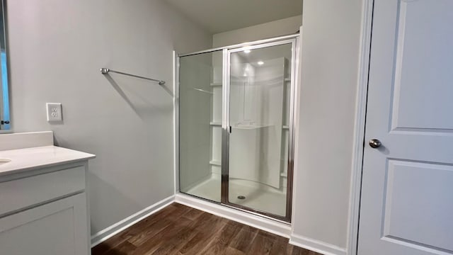 bathroom with vanity, hardwood / wood-style floors, and walk in shower