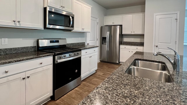 kitchen featuring stainless steel appliances, dark wood-type flooring, white cabinetry, and sink