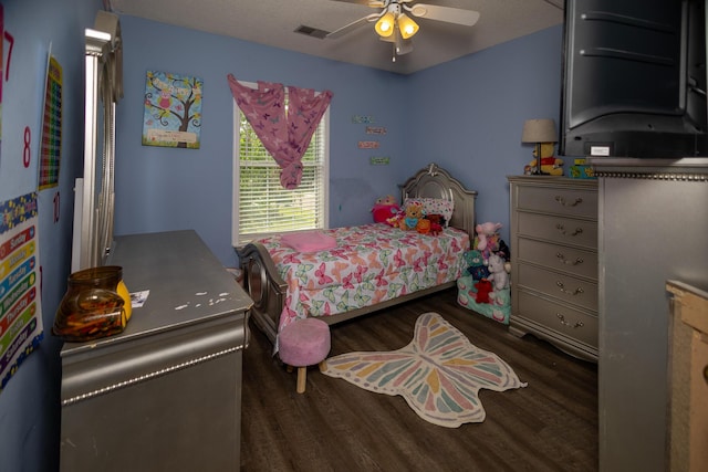 bedroom with wood finished floors and a ceiling fan