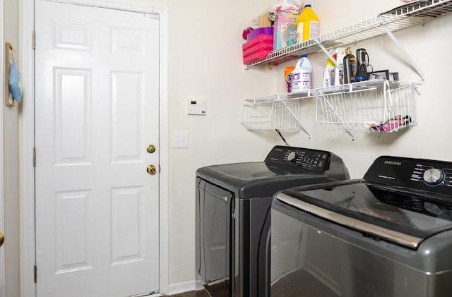 clothes washing area featuring washer and clothes dryer