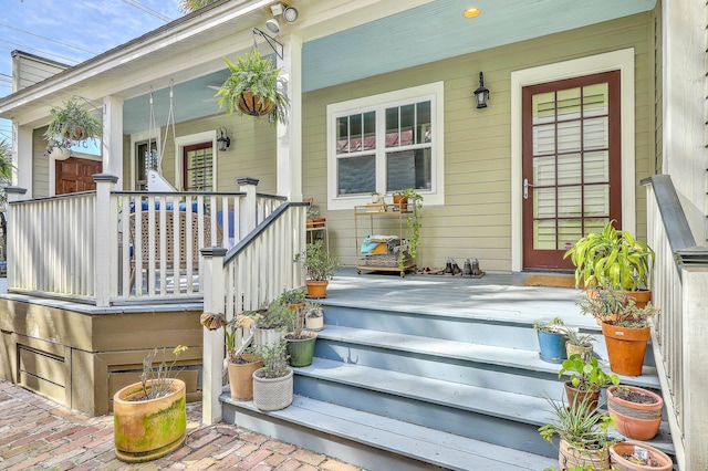 view of exterior entry featuring a porch