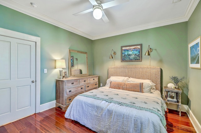 bedroom featuring crown molding, dark wood-style flooring, and baseboards