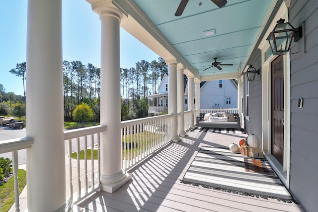 wooden terrace with ceiling fan and a porch