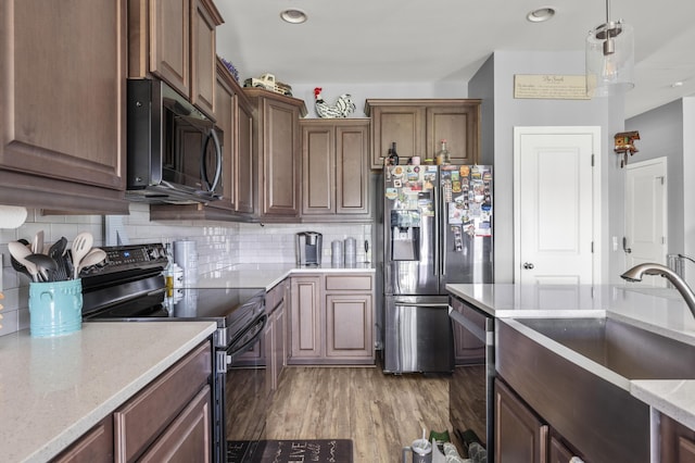 9009 Chato Ct, Summerville, SC 29483 - kitchen featuring appliances with stainless steel finishes, a sink, decorative backsplash, light wood-style floors, and pendant lighting